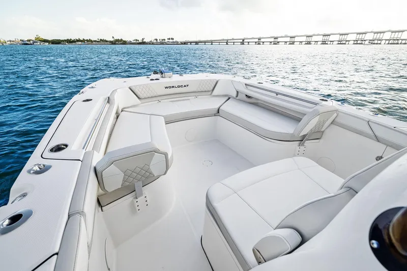 Slide: The Image of 2026 World Cat 325CC boat interior with white seating, on calm blue water. - 12