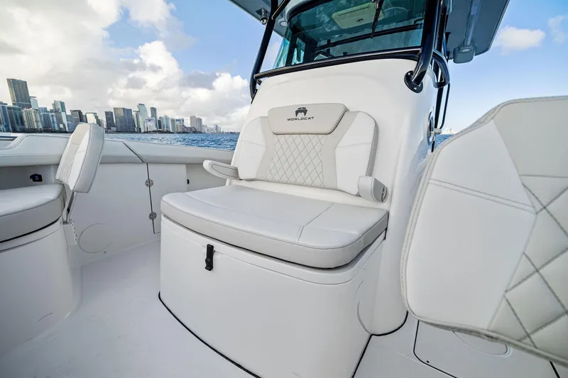 Slide: The Image of 2026 World Cat 325CC boat interior with luxurious seating, city skyline in background. - 15