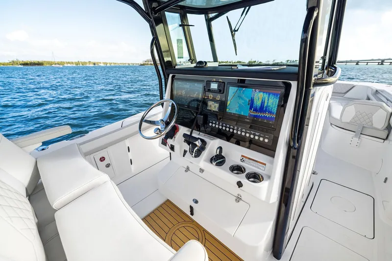 Slide: The Image of 2026 World Cat 325CC boat cockpit with advanced navigation systems and luxurious seating. - 19