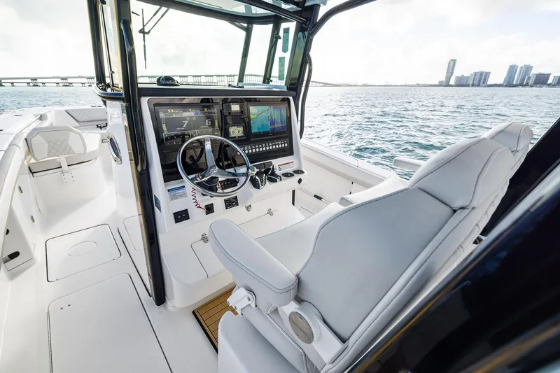 Slide: The Image of 2026 World Cat 325CC boat interior with modern dashboard and ocean view. - 20