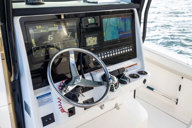 Slide: The Image of 2026 World Cat 325CC boat dashboard with advanced navigation and control systems. - 21