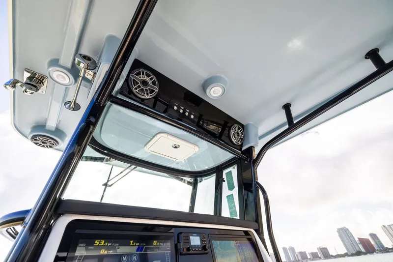 Slide: The Image of Interior view of 2026 World Cat 325CC boat dashboard with speakers and controls. - 23