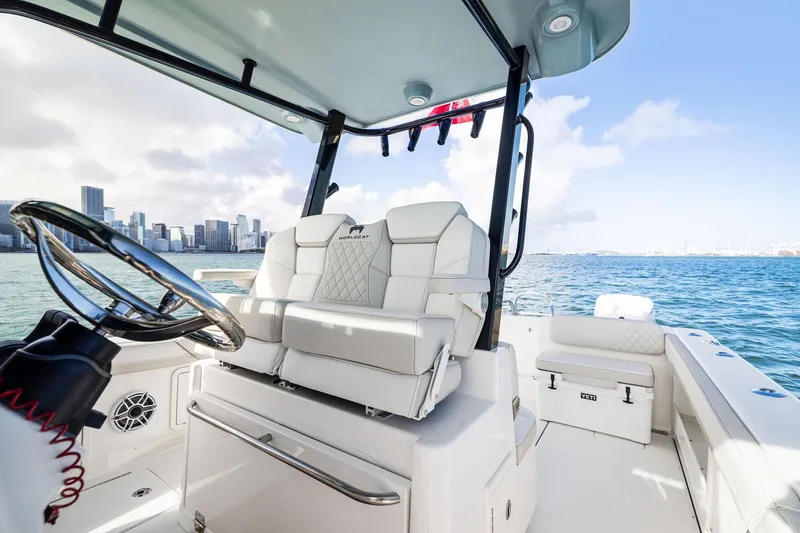 Slide: The Image of 2026 World Cat 325CC boat interior with city skyline and ocean view. - 24