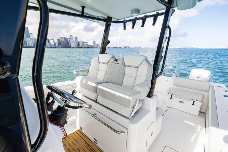 Slide: The Image of 2026 World Cat 325CC boat interior with city skyline in the background. - 26