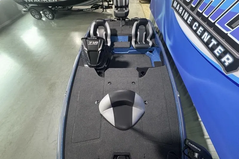 Slide: The Image of 2026 Nitro Z18 Pro boat interior with seating and control panel at a marine center. - 31