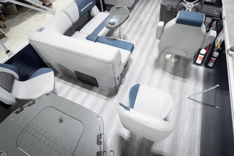 Slide: The Image of 2026 Bennington 20 SFC boat interior with gray and blue seating, Reeder-Trausch Marine logo. - 14