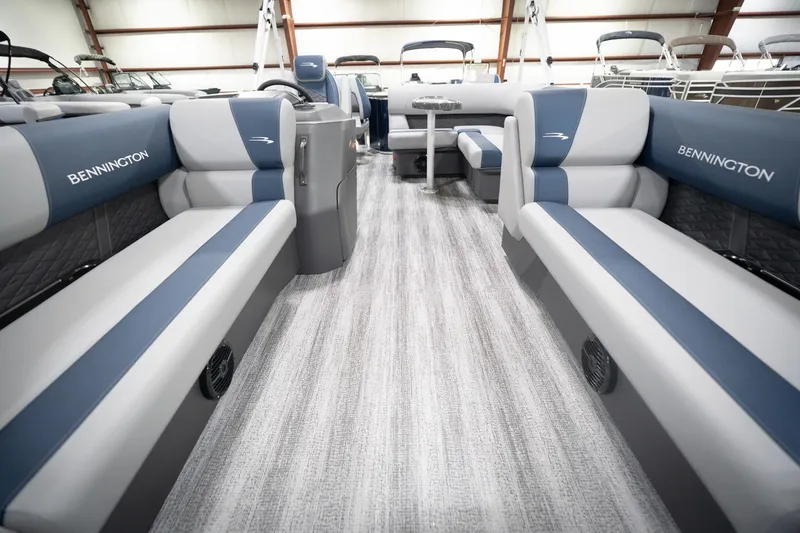 Slide: The Image of 2026 Bennington 20 SFC boat interior with gray and blue seating, modern design. - 16