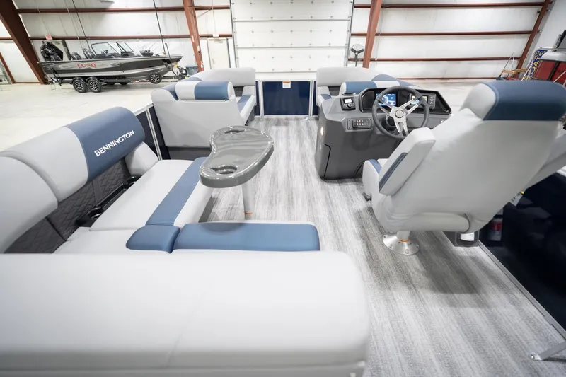 Slide: The Image of 2026 Bennington 20 SFC boat interior with modern seating and sleek design in showroom. - 19