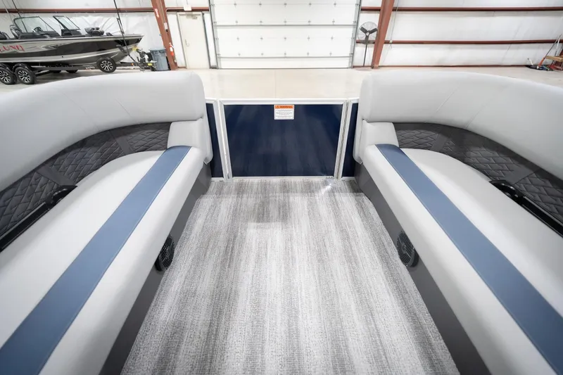 Slide: The Image of 2026 Bennington 20 SFC pontoon boat interior with plush seating and modern dashboard. - 21