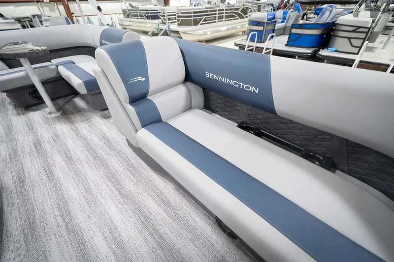 Slide: The Image of Interior of 2026 Bennington 20 SFC pontoon boat with gray seating and blue accents. - 22