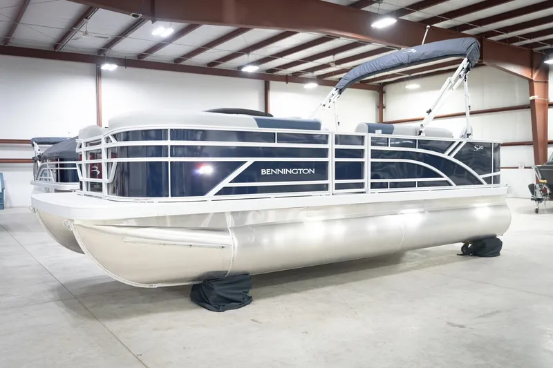 Slide: The Image of 2026 Bennington 20 SFC pontoon boat in showroom, featuring sleek design and modern amenities. - 3