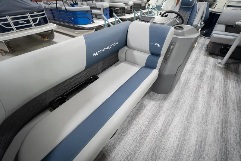 Slide: The Image of 2026 Bennington 20 SFC boat interior with blue and gray seating, Reeder-Trausch Marine logo. - 49