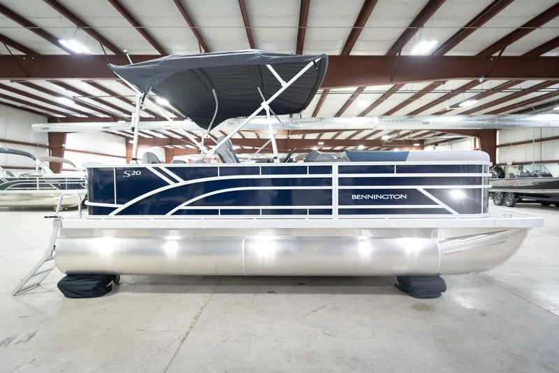Slide: The Image of 2026 Bennington 20 SFC pontoon boat in showroom with canopy and sleek design. - 7