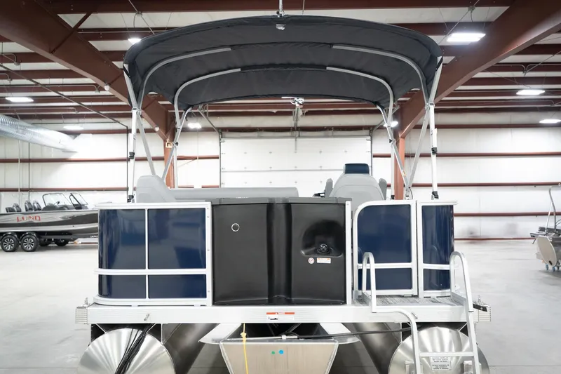 Slide: The Image of 2026 Bennington 20 SFC pontoon boat in showroom with canopy and sleek design. - 9