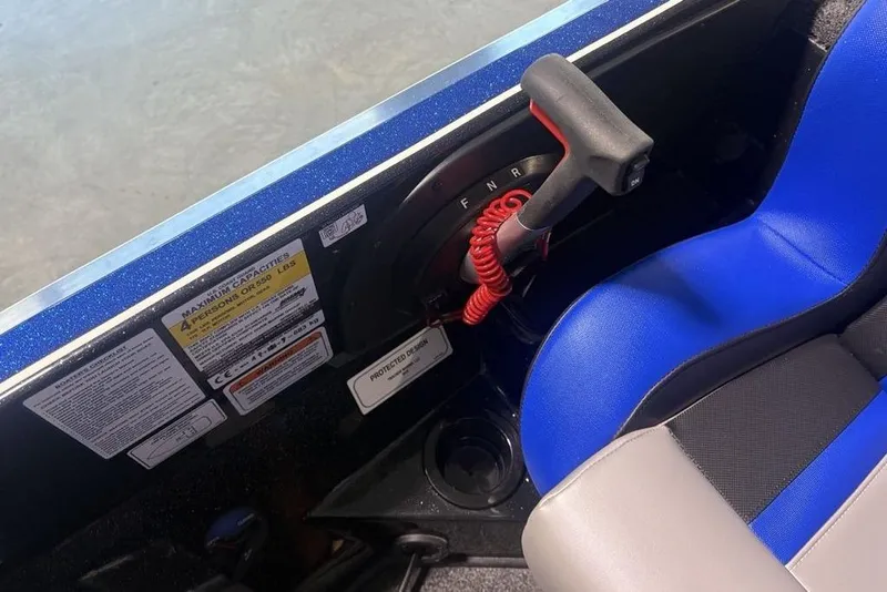 Slide: The Image of Control panel and seat of a 2026 Nitro Z18 Pro boat, featuring safety labels. - 25