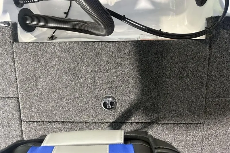 Slide: The Image of Carpeted interior of 2026 Nitro Z18 Pro boat with visible tubing and latch. - 28