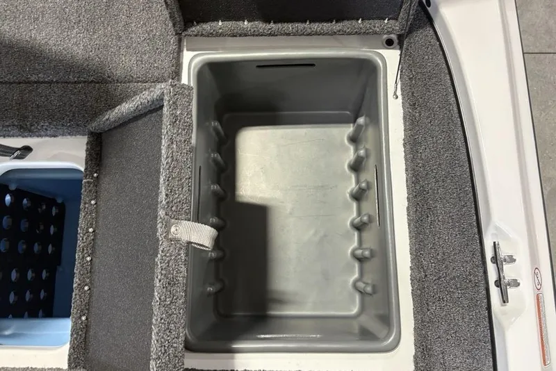 Slide: The Image of Open storage compartment in a 2026 Nitro Z17 boat, featuring carpeted interior and secure latch. - 26