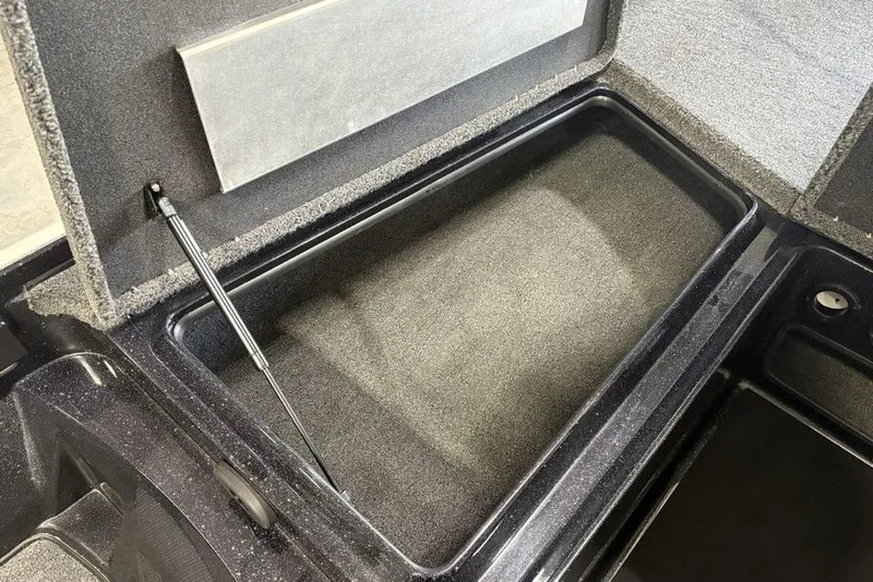 Slide: The Image of Open storage compartment in 2026 Nitro Z17 boat, featuring carpeted interior and hydraulic lift. - 7