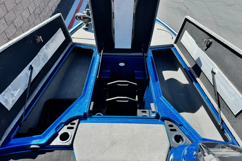 Slide: The Image of 2022 Nitro Z19 boat interior storage compartments, open and empty, showcasing blue and gray design. - 10