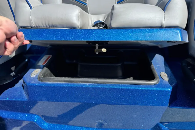 Slide: The Image of 2022 Nitro Z19 boat storage compartment with blue glitter finish and gray seating. - 13
