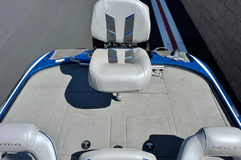 Slide: The Image of 2022 Nitro Z19 boat interior with gray seating and blue accents. - 14