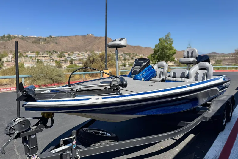 Slide: The Image of 2022 Nitro Z19 boat on trailer, parked with scenic mountain backdrop. - 3