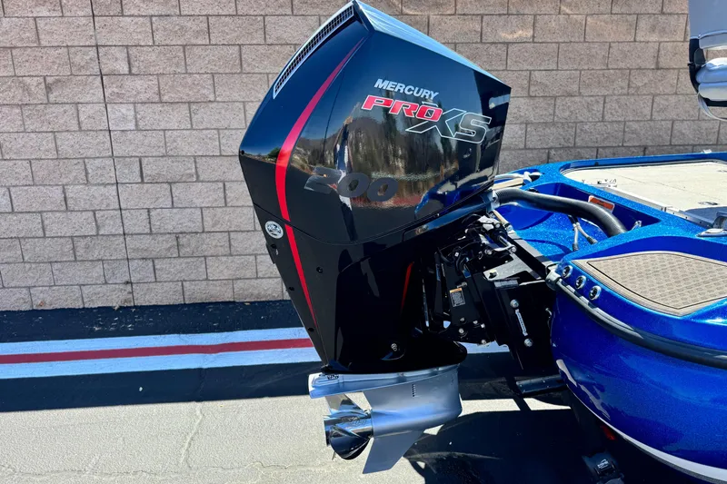 Slide: The Image of 2022 Nitro Z19 boat with Mercury Pro XS engine, blue exterior, parked by brick wall. - 6