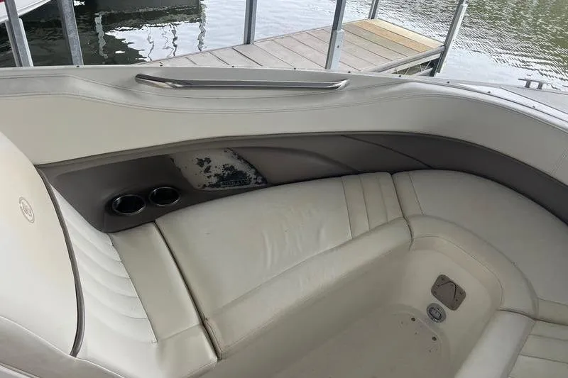 Slide: The Image of Interior of a 2003 Cobalt 282 boat with white seating and cup holders. - 11
