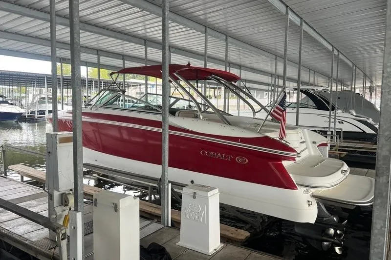 Slide: The Image of Red 2003 Cobalt 282 boat docked in covered marina. - 13