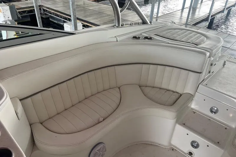 Slide: The Image of Luxurious seating on a 2003 Cobalt 282 boat, featuring cream upholstery and cup holders. - 15