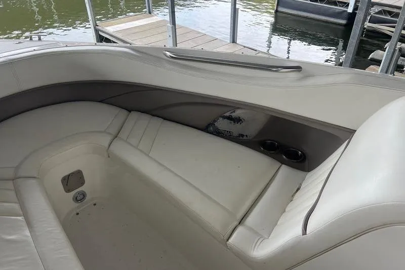 Slide: The Image of Interior of a 2003 Cobalt 282 boat with white leather seating and cup holders. - 3