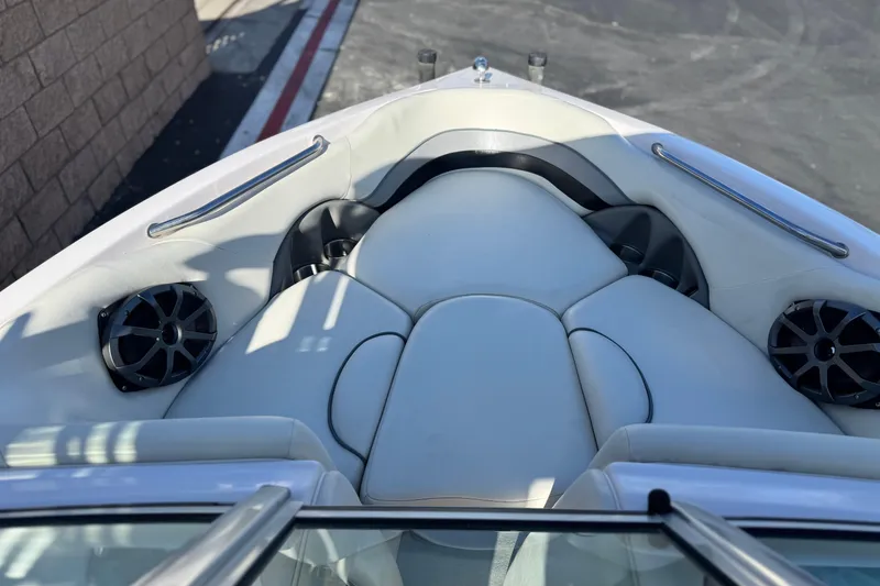 Slide: The Image of 2006 Correct Craft Super Air Nautique 210 Sport boat interior with speakers and cushioned seating. - 14