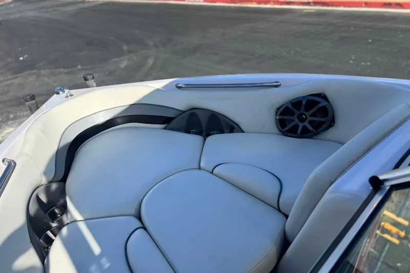 Slide: The Image of 2006 Correct Craft Super Air Nautique 210 Sport boat interior with cushioned seating and speaker. - 16