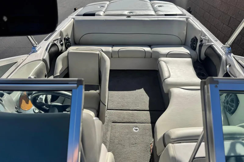 Slide: The Image of 2006 Correct Craft Super Air Nautique 210 Sport boat interior with gray seating and carpet. - 17