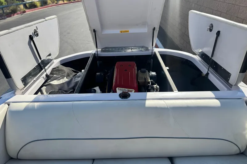 Slide: The Image of 2006 Correct Craft Super Air Nautique 210 Sport engine compartment with open hatches. - 19