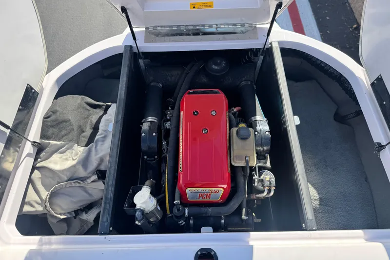 Slide: The Image of 2006 Correct Craft Super Air Nautique 210 Sport engine compartment with red PCM engine. - 20