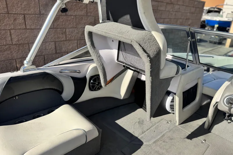 Slide: The Image of 2006 Correct Craft Super Air Nautique 210 Sport interior with seating and speaker details. - 23