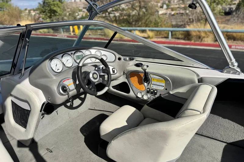 Slide: The Image of 2006 Correct Craft Super Air Nautique 210 Sport boat interior with steering wheel and dashboard. - 25
