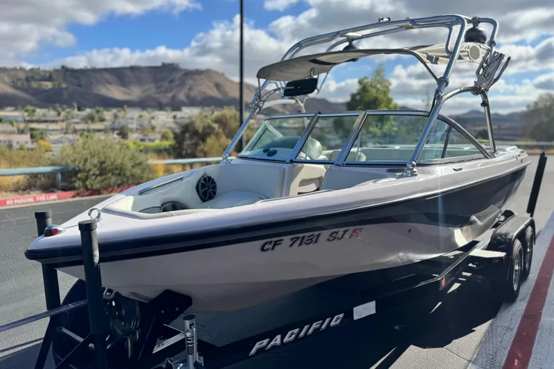 Slide: The Image of 2006 Correct Craft Super Air Nautique 210 Sport boat on trailer, scenic background. - 3