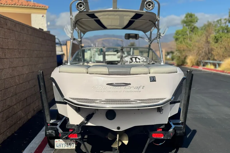 Slide: The Image of 2006 Correct Craft Super Air Nautique 210 Sport boat on trailer, rear view. - 4