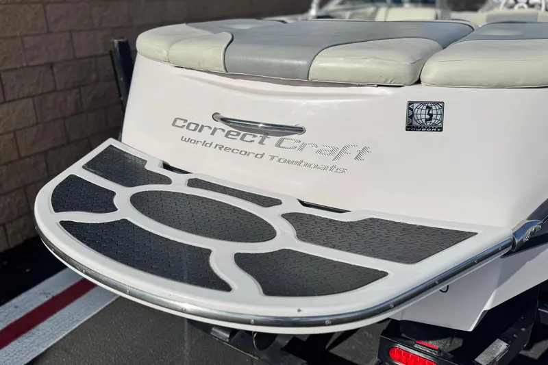 Slide: The Image of 2006 Correct Craft Super Air Nautique 210 Sport boat rear view with swim platform. - 6