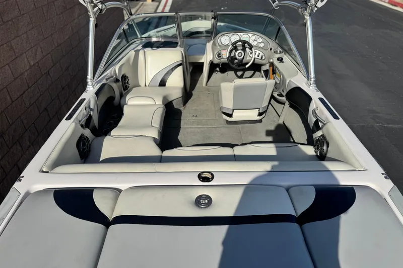 Slide: The Image of 2006 Correct Craft Super Air Nautique 210 Sport boat interior with seating and steering wheel. - 8