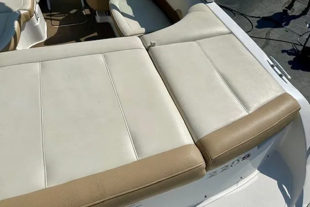 Slide: The Image of 2015 Cobalt 220S boat with beige and white seating, viewed from above. - 10