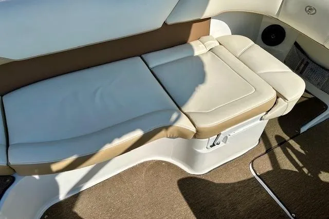 Slide: The Image of 2015 Cobalt 220S boat interior with beige and white cushioned seating. - 11