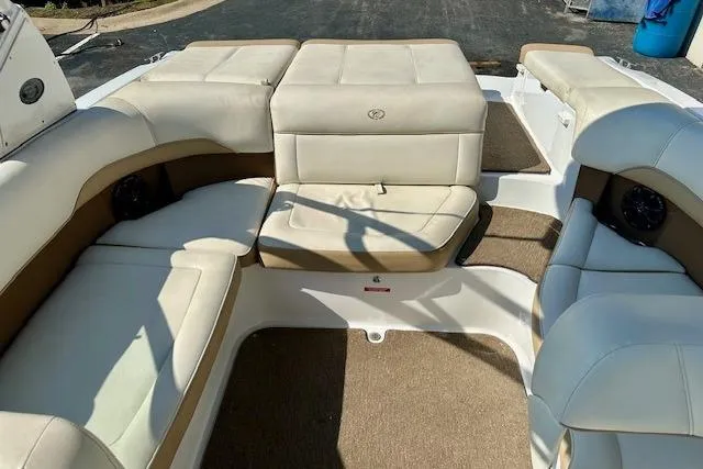 Slide: The Image of 2015 Cobalt 220S boat interior with beige seating and brown accents. - 12