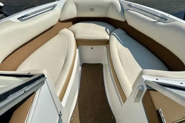 Slide: The Image of 2015 Cobalt 220S boat interior with beige and white seating. - 13