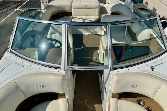 Slide: The Image of 2015 Cobalt 220S boat interior with white leather seating and windshield. - 14