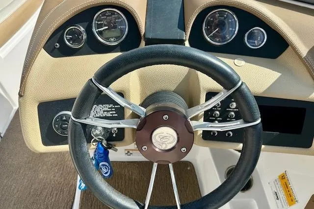 Slide: The Image of Steering wheel and dashboard of a 2015 Cobalt 220S boat. - 16