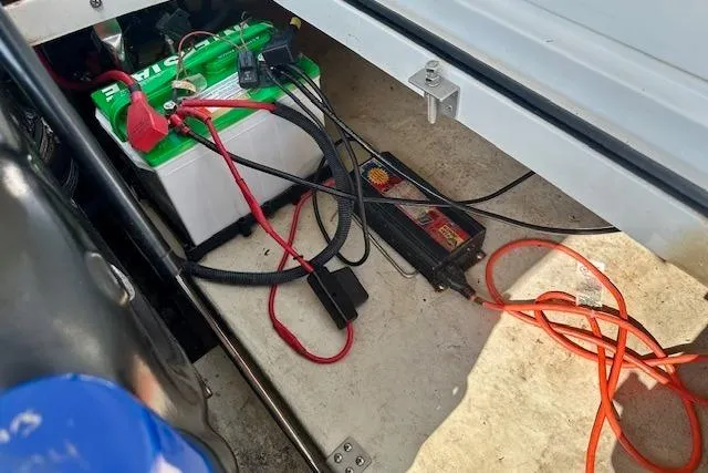 Slide: The Image of Battery and charger setup in a 2015 Cobalt 220S boat compartment. - 18