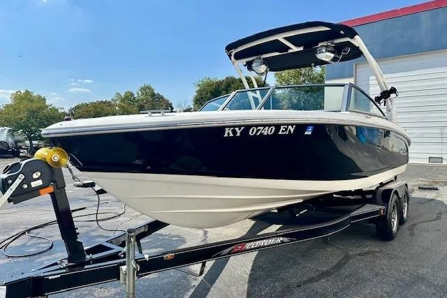 Slide: The Image of 2015 Cobalt 220S boat on trailer, black and white exterior, parked outdoors. - 3
